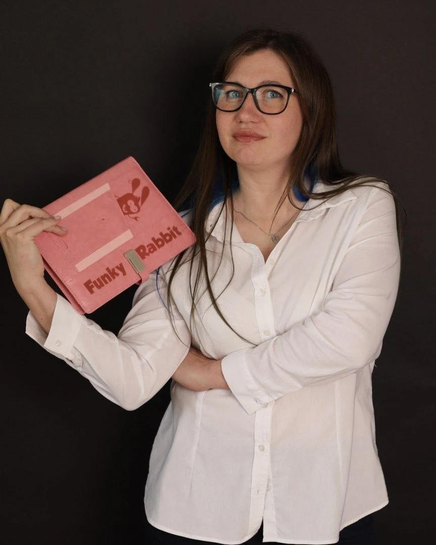 Mariia Reznichenko, founder and lead designer of Funky Rabbit, holding the Funky Rabbit brand book